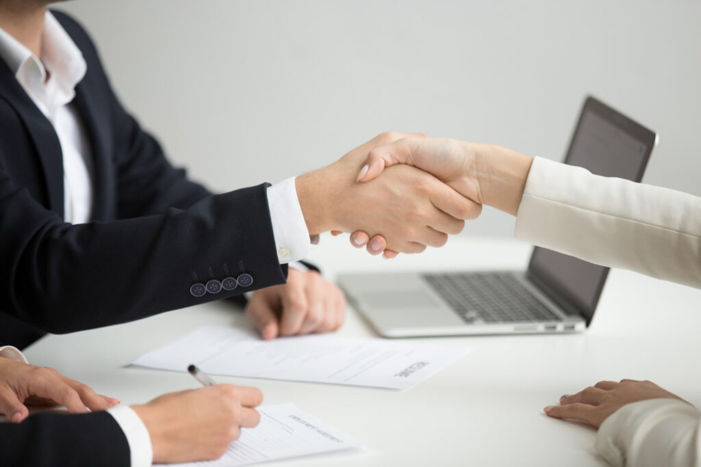 hr-handshaking-successful-candidate-getting-hired-new-job-closeup
